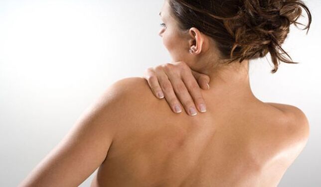 Woman worried about pain under left shoulder blade in back from behind