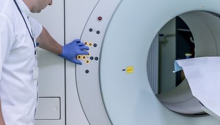 The doctor controls the MRI apparatus
